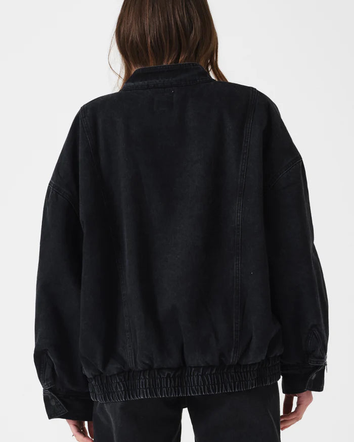 Person wearing a black jacket on a white background