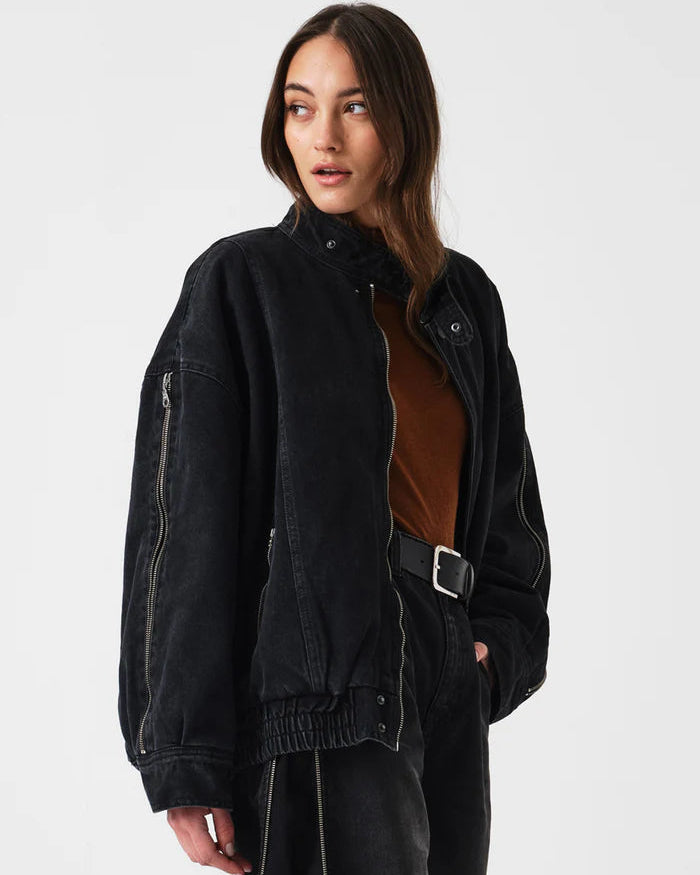 Person wearing a black jacket and pants on a white background