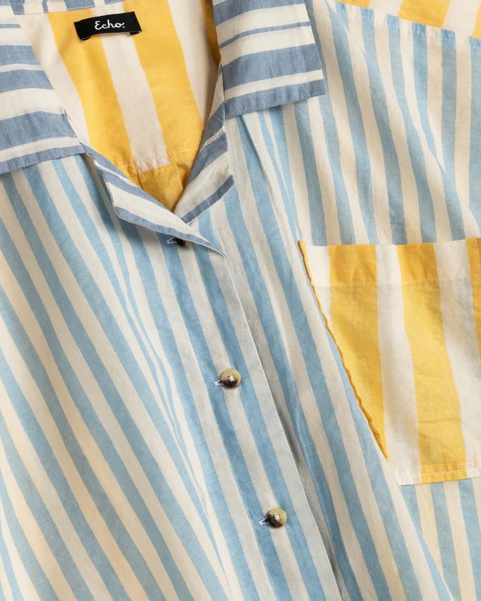 Close-up of a striped shirt with yellow and blue pattern and 'Echo' label.