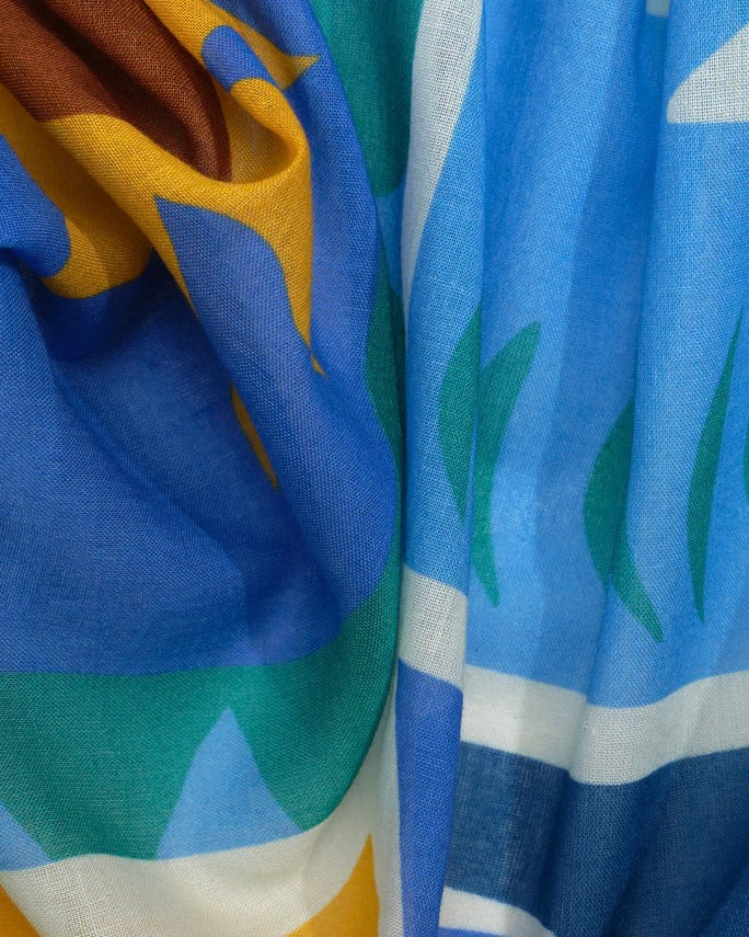 Close-up of colorful fabric with blue, green, and brown patterns.