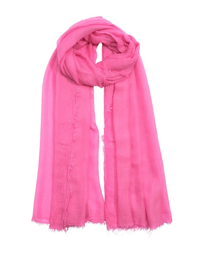 Pink scarf with frayed edges on a white background