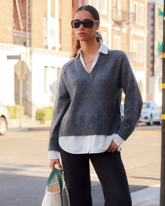 Model in the Carrie Mixed Media Sweater standing in front of a building.