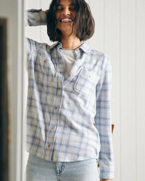 Model wearing Faherty Legend Sweater Shirt Spring Dew Plaid wearing jeans on a white background