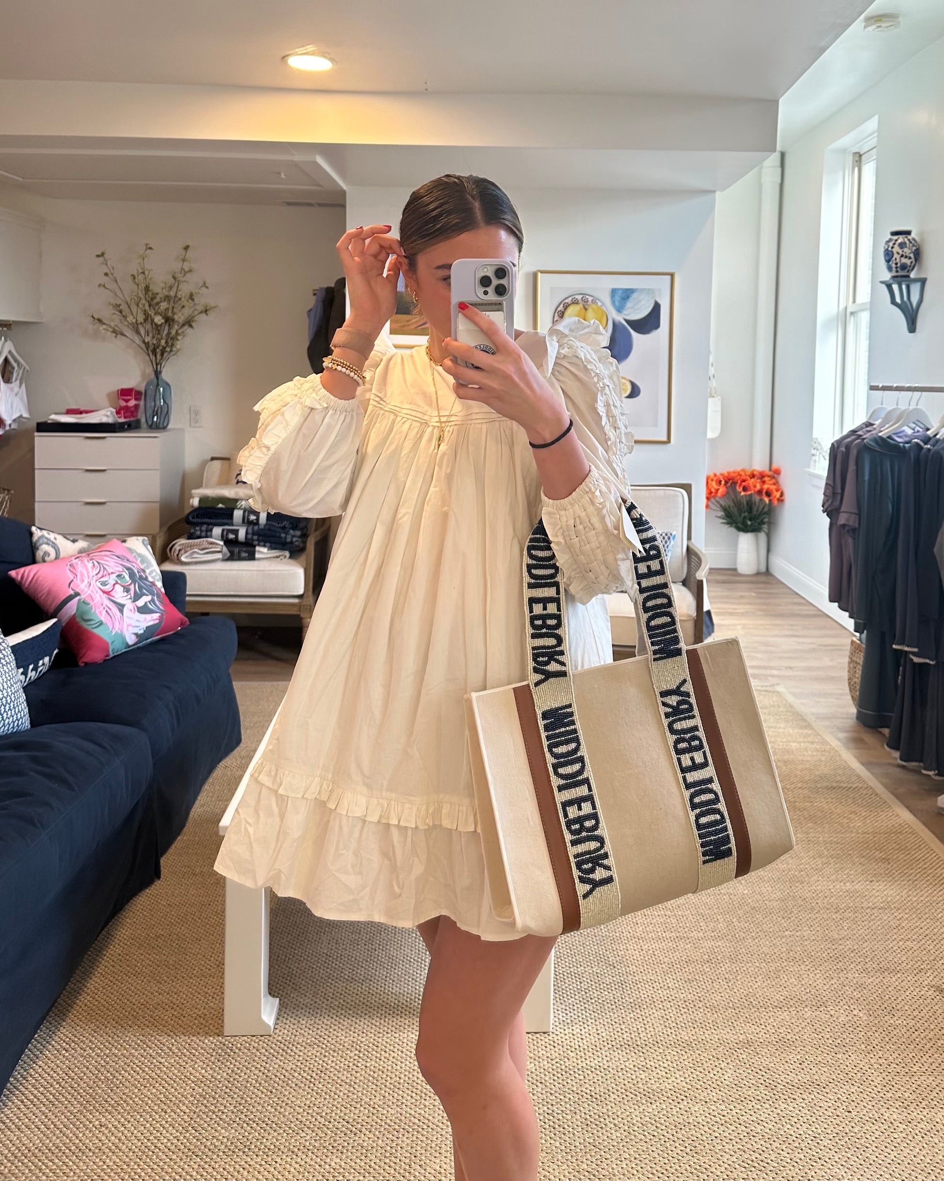 Model wearing White dress taking a selfie with Middlebury College Beaded Canvas MIDDLEBURY Tote in store