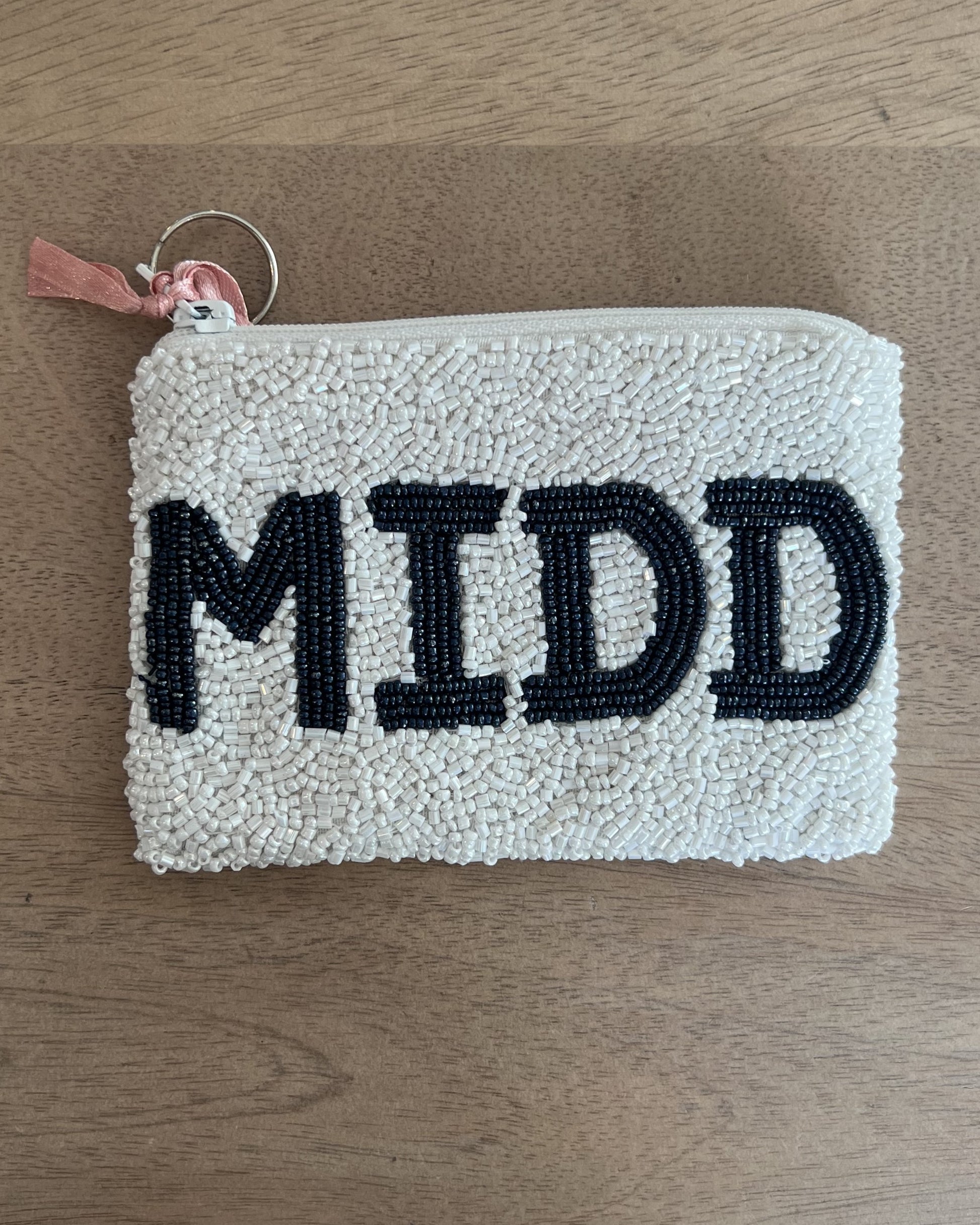 Image of Middlebury College Lacrosse White/Navy Coin purse on a brown background