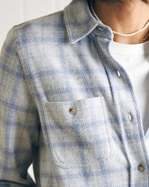 Model wearing Faherty Legend Sweater Shirt Spring Dew Plaid wearing a white tee and a pearl necklace on a white background
