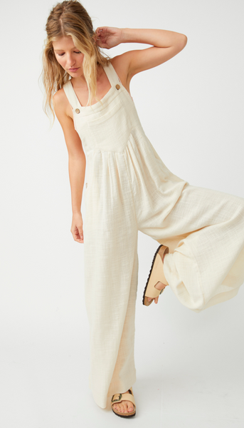 Model wearing Free People Sun-Drenched Overalls wearing sandals on a white background