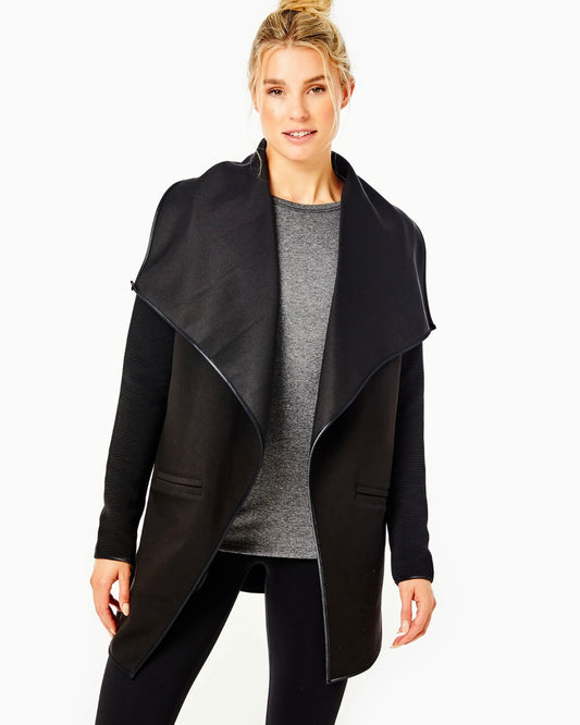 Model wearing Addison Bay The Wrap jacket in Black wearing black leggings and gray shirt on a white background