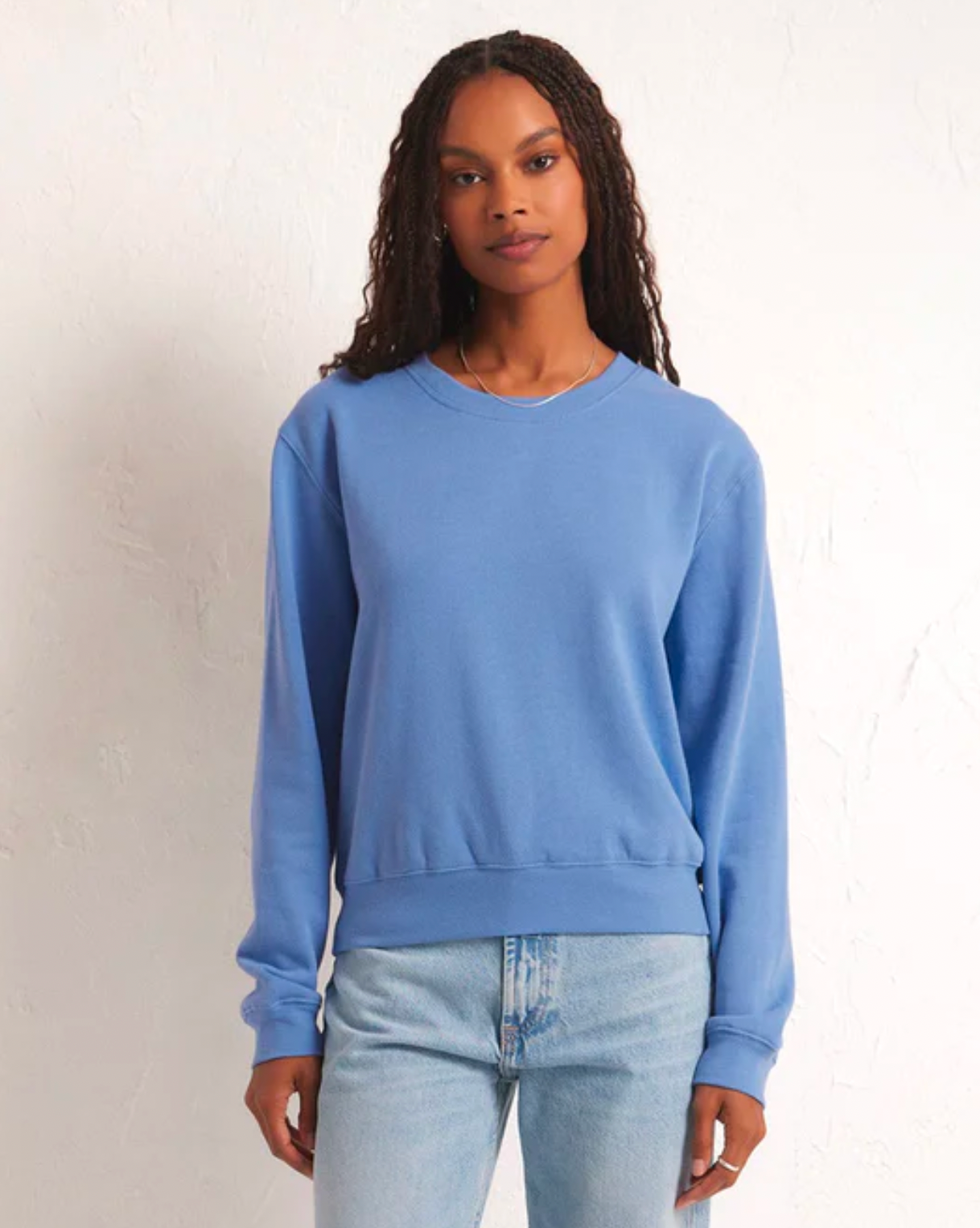 Model wearing Z Supply Blue Classic Crew Sweatshirt wearing jeans on a white background