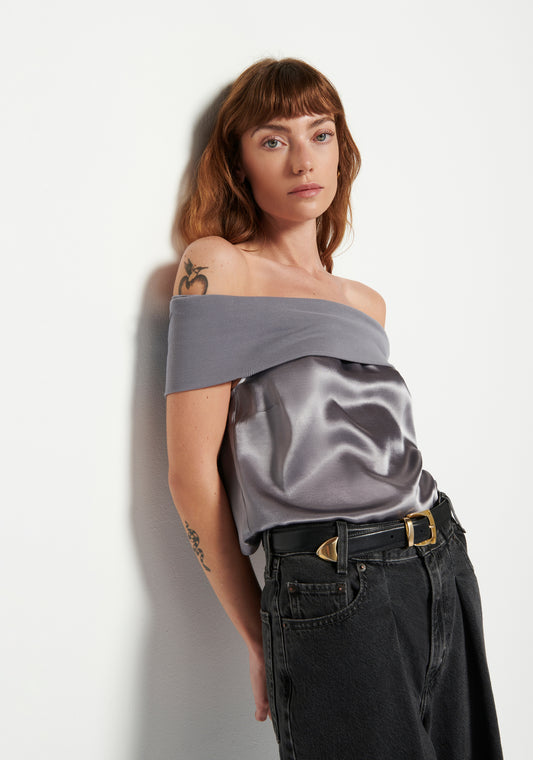 Model wearing Nation Vera Off-The-Shoulder Top in the color smoke wearing black pants on a white background