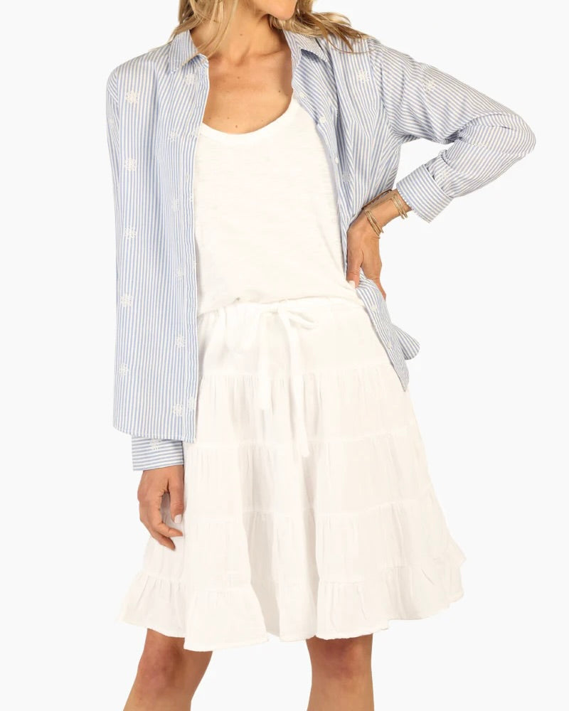 Model wearing Dylan White Gauze Sophie Skirt wearing blue and white shirt over white tank on a white background