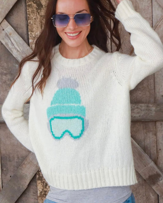Model Wearing Wooden Ships Ski Babe Crewneck pure snow color wearing sunglasses on a barn door background