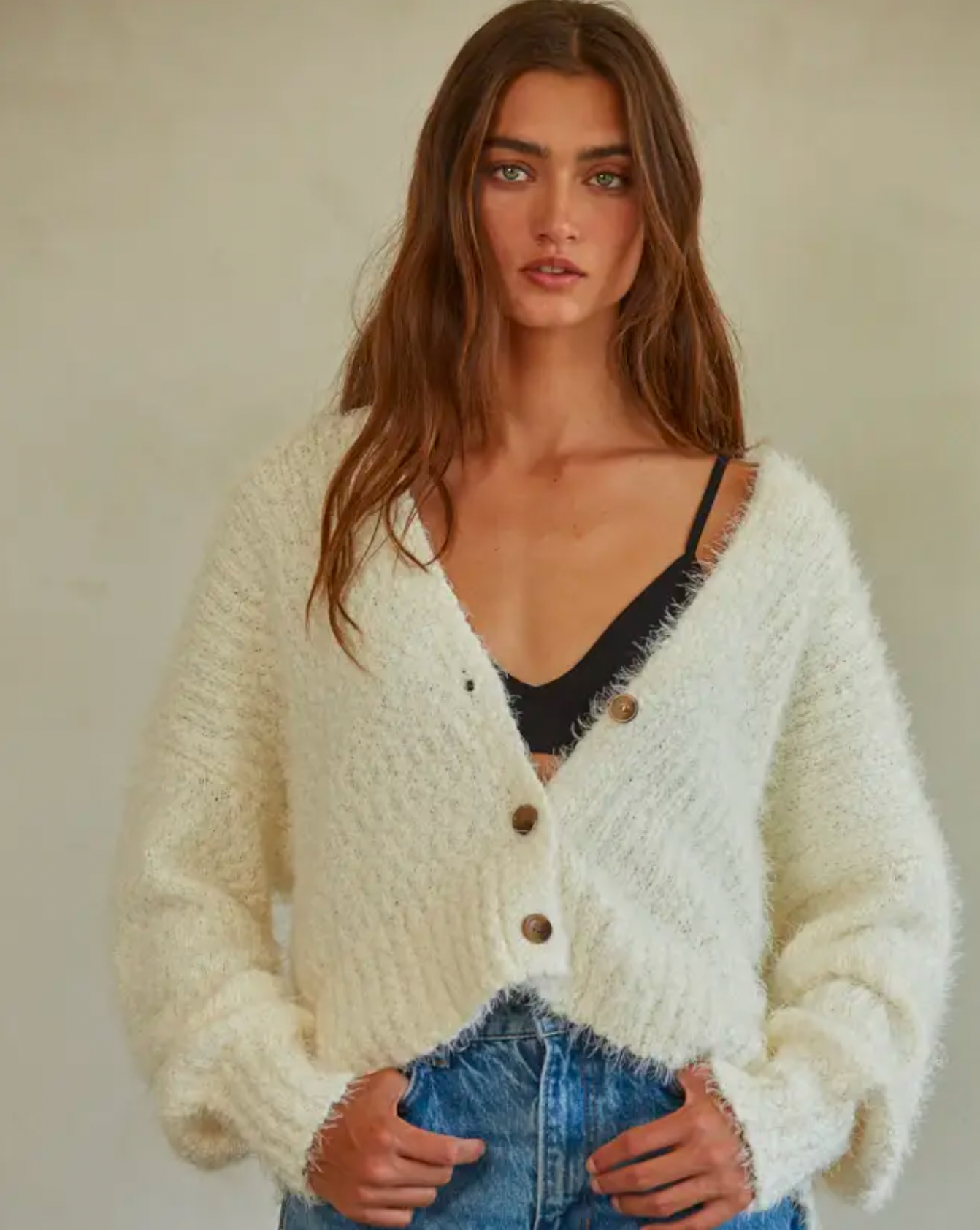 Model Wearing By Together The Brielle Cozy Cardigan wearing jeans and a black bra on a off white background