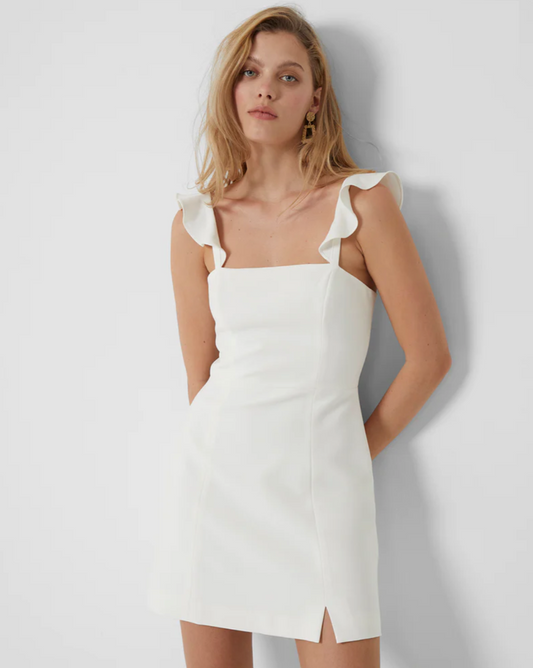 Model wearing French Connection Whisper Ruffle Strap Dress in summer white on a white background