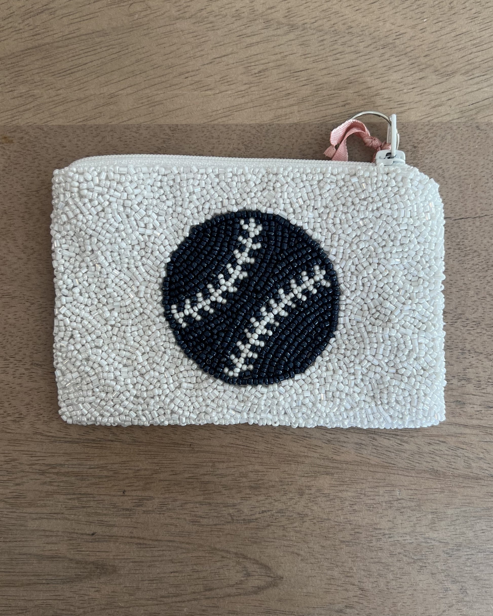 Image of Middlebury College Baseball coin purse in white/Navy on a wood background
