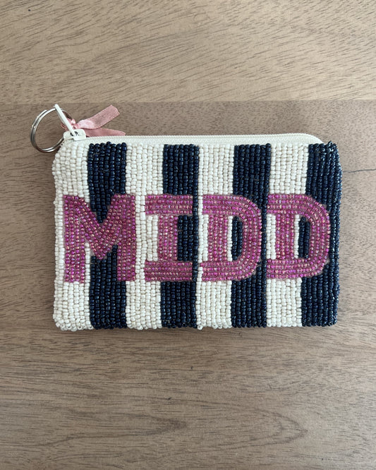 Image of Middlebury Vermont State Coin purse with pink letters and blue/white stripes on a brown background