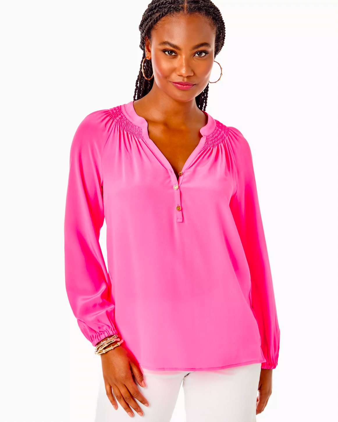 Model wearing Lilly Pulitzer Elsa Silk Top in aura pink color wearing white jeans on a white background