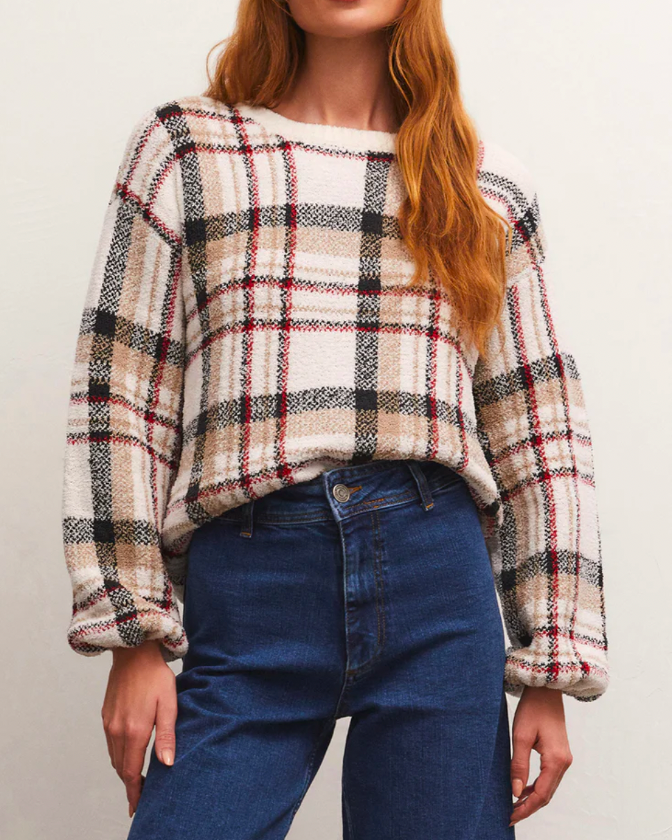 Model wearing Z Supply Solange plaid sweater wearing jeans on a white background