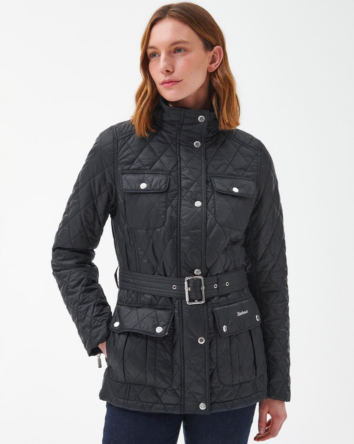 Model Wearing Barbour Belted Country Utility Quilt Black/Rose Garden Floral Coat Wearing Jeans On A White Background