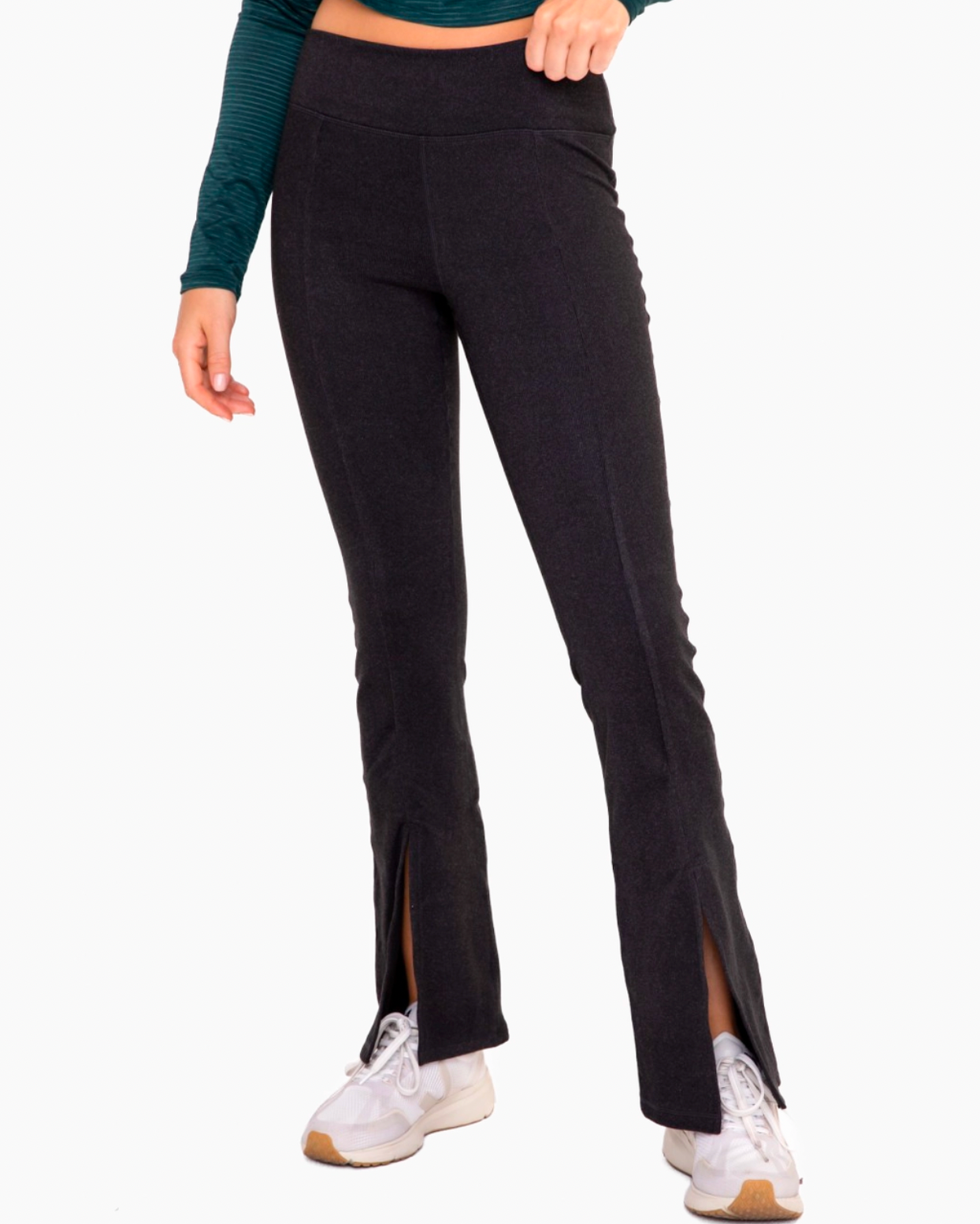 Model wearing Mono B Ribbed Flare Leggings wearing white sneakers and green shirt on a white background